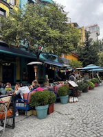 Colorful mountain cafes buzzing with friends sipping chai and sharing stories.