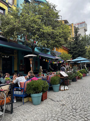 Colorful mountain cafes buzzing with friends sipping chai and sharing stories.
