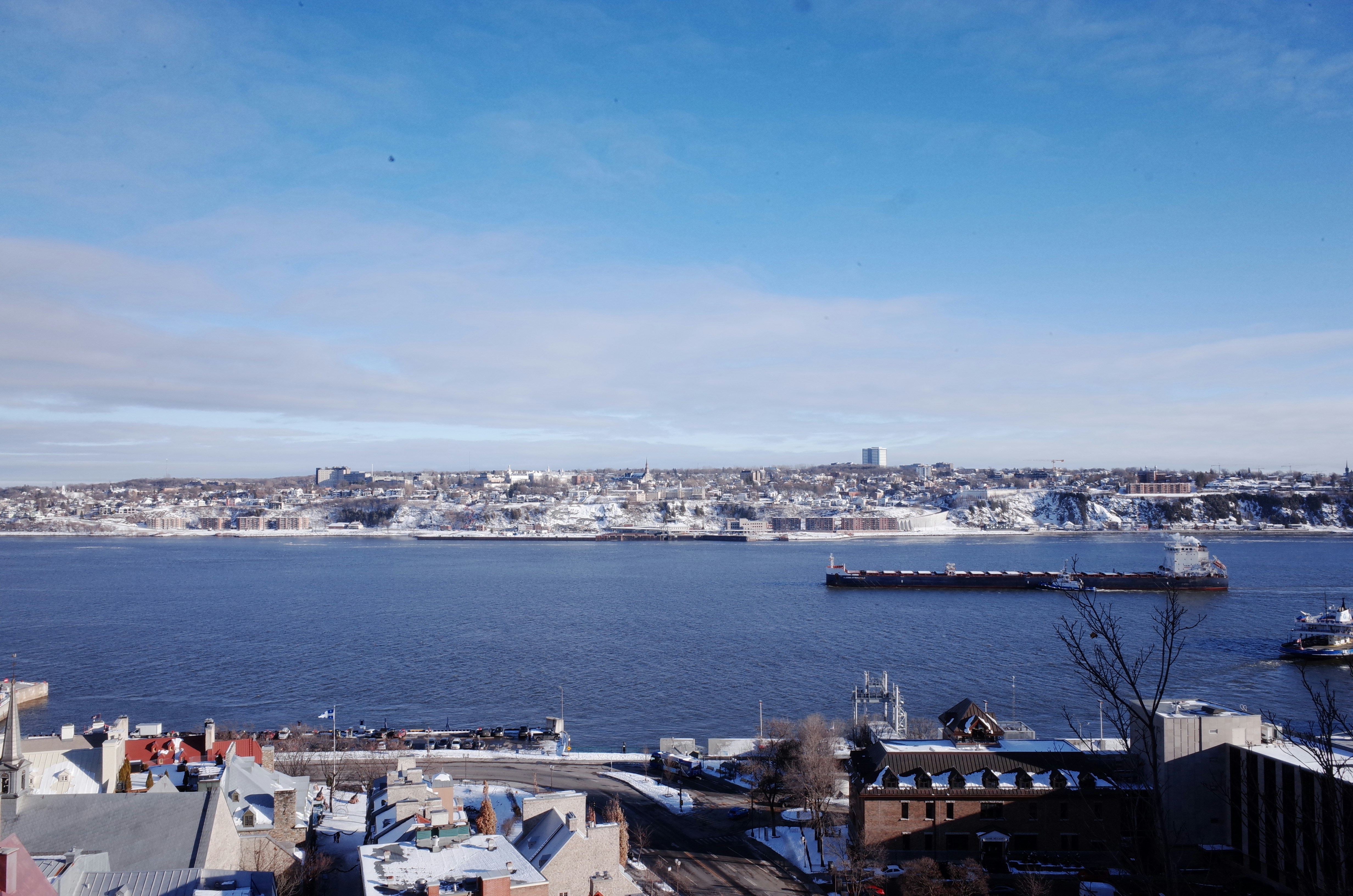 a large body of water sitting next to a city
