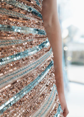 Close-up of María José’s blue and gold dress shimmering in the evening light.