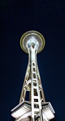 Side view of a solar lighting tower with its bright white light cutting through the darkness.