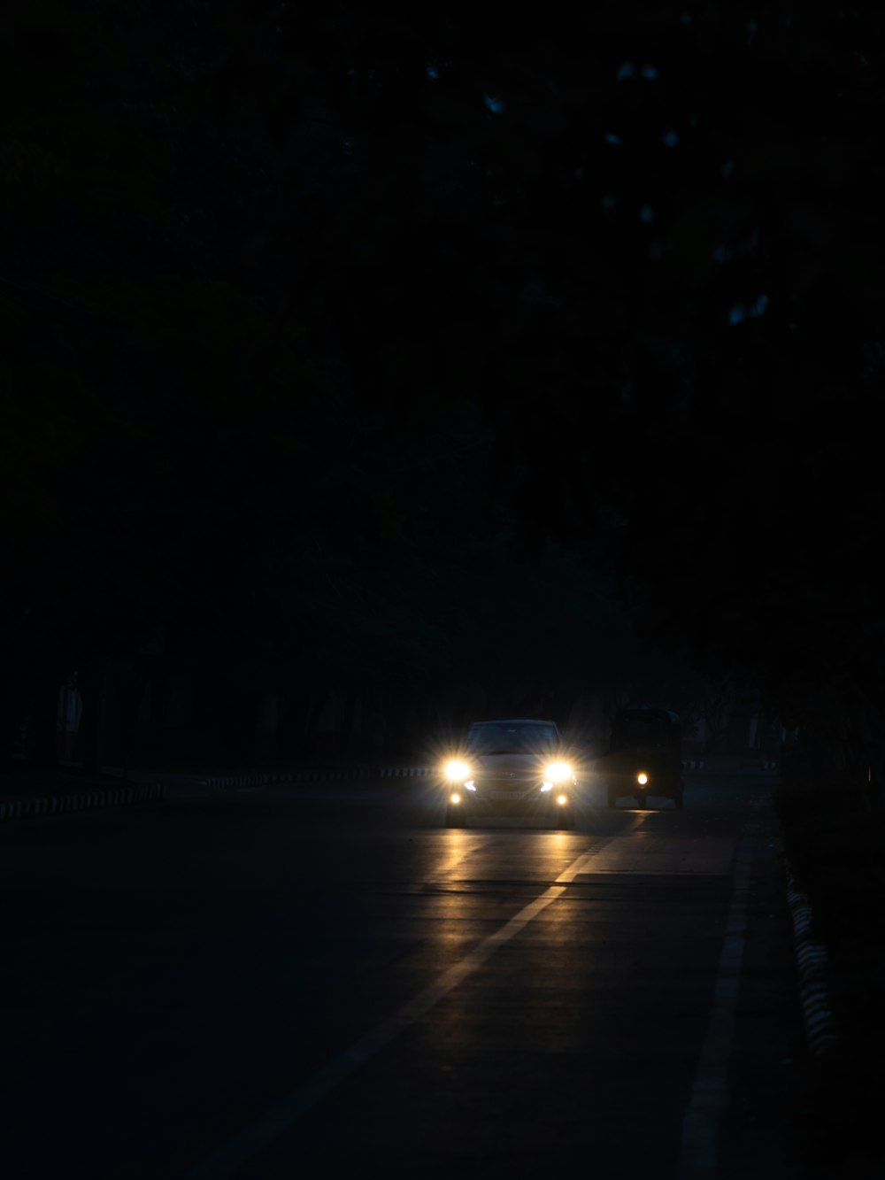 a car driving down a street at night