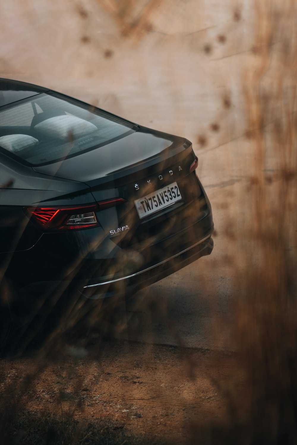 a black car parked on the side of a road