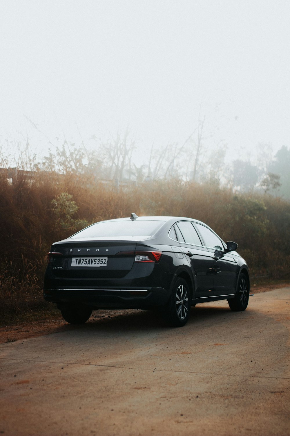 a black car parked on the side of a road