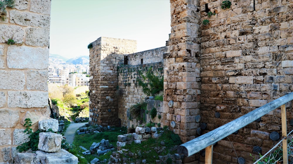 a stone building with a wooden hand rail in front of it