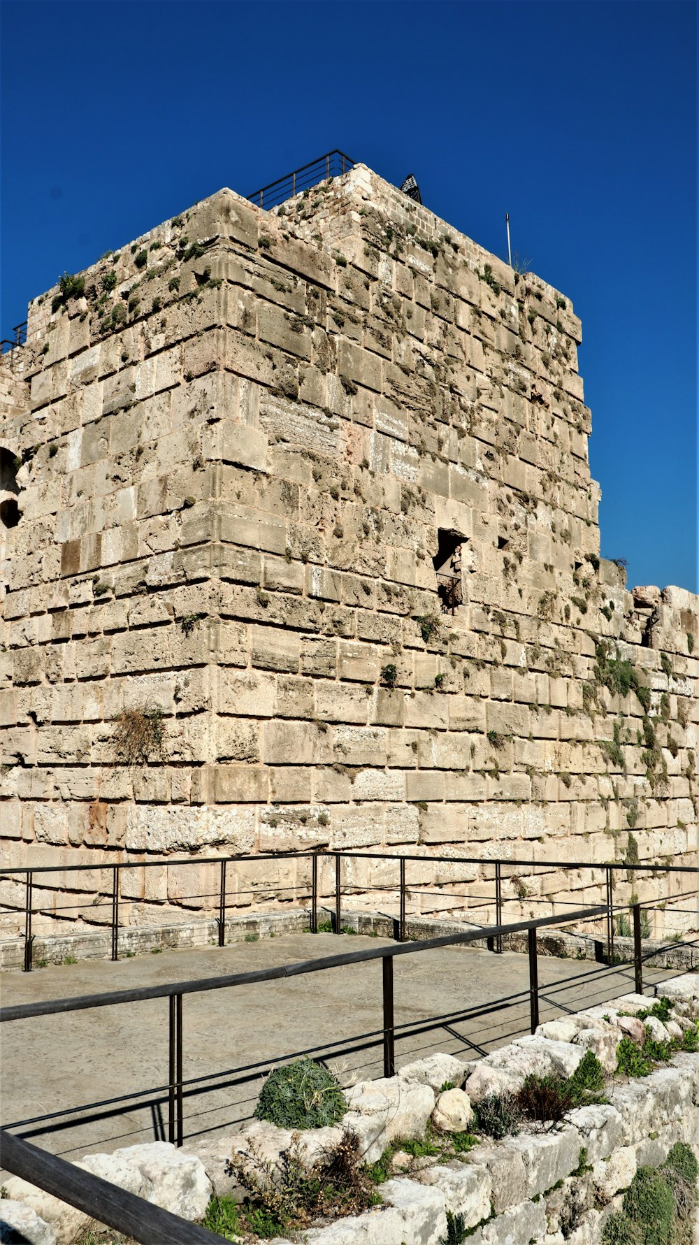 a large stone structure with a fence around it