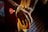 Close-up of hands holding prayer beads with a blurred mosque background.
