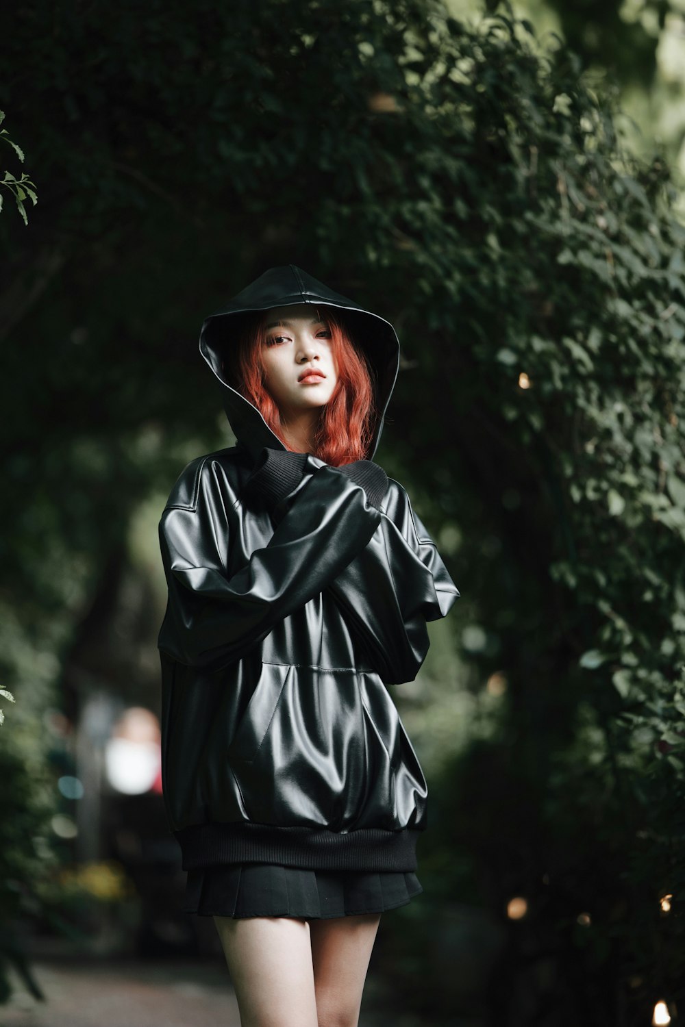 a woman with red hair is walking down the street