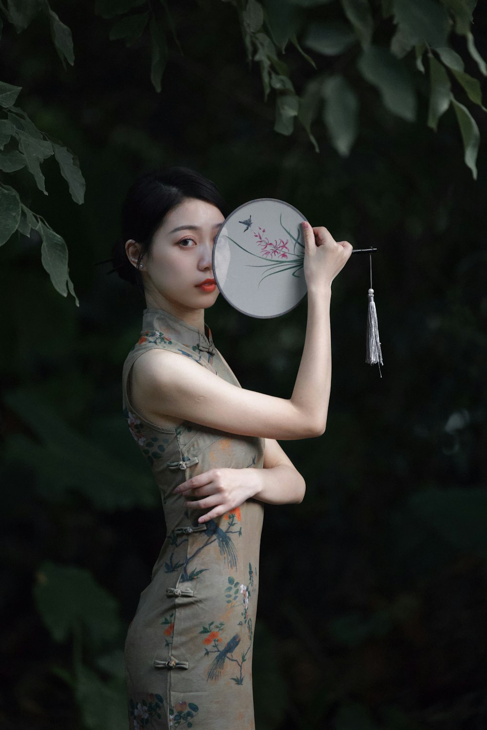 a woman in a dress holding a frisbee