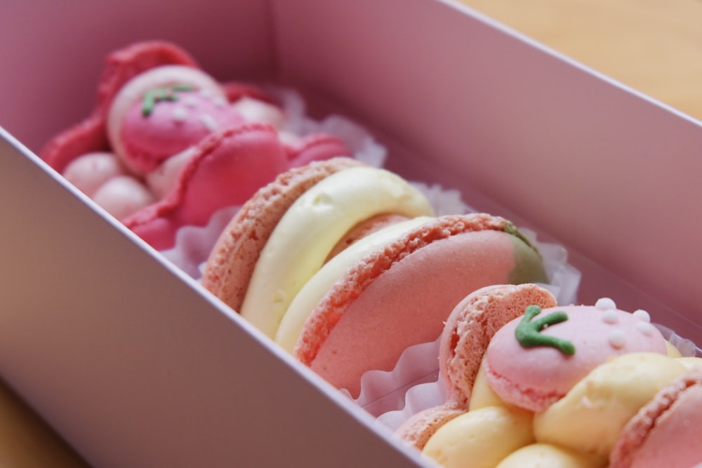 a box filled with assorted pastries on top of a table