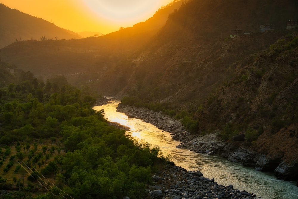 a river running through a lush green hillside