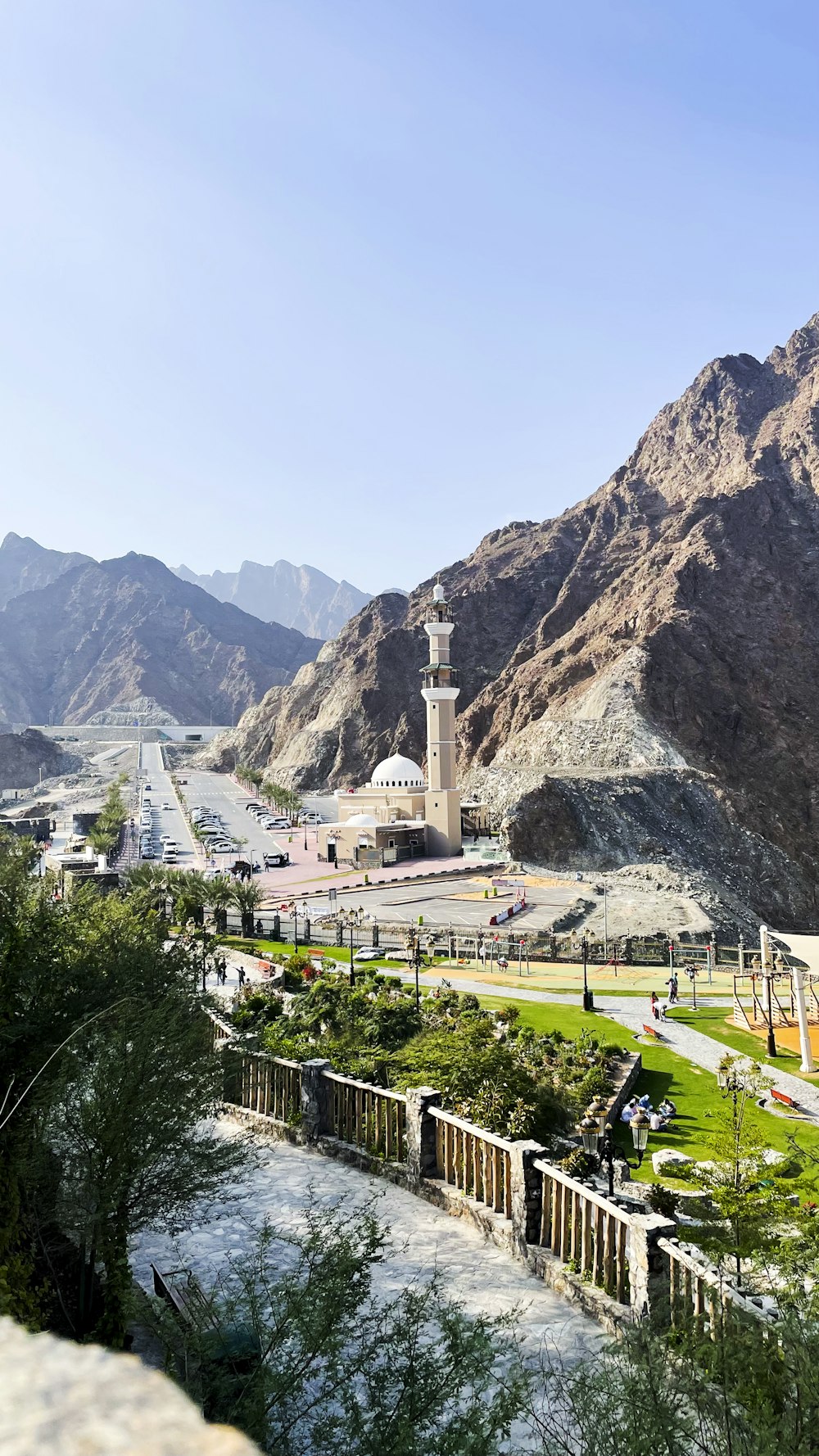 a view of a mountain with a white building in the middle