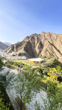 a scenic view of a mountain range with a building in the foreground