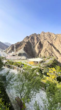 a scenic view of a mountain range with a building in the foreground