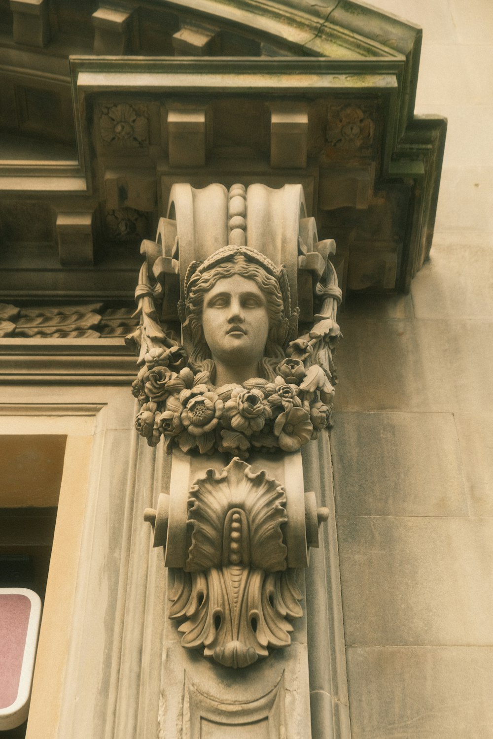 a statue of a woman's head on the side of a building