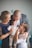 a man and two women holding a baby