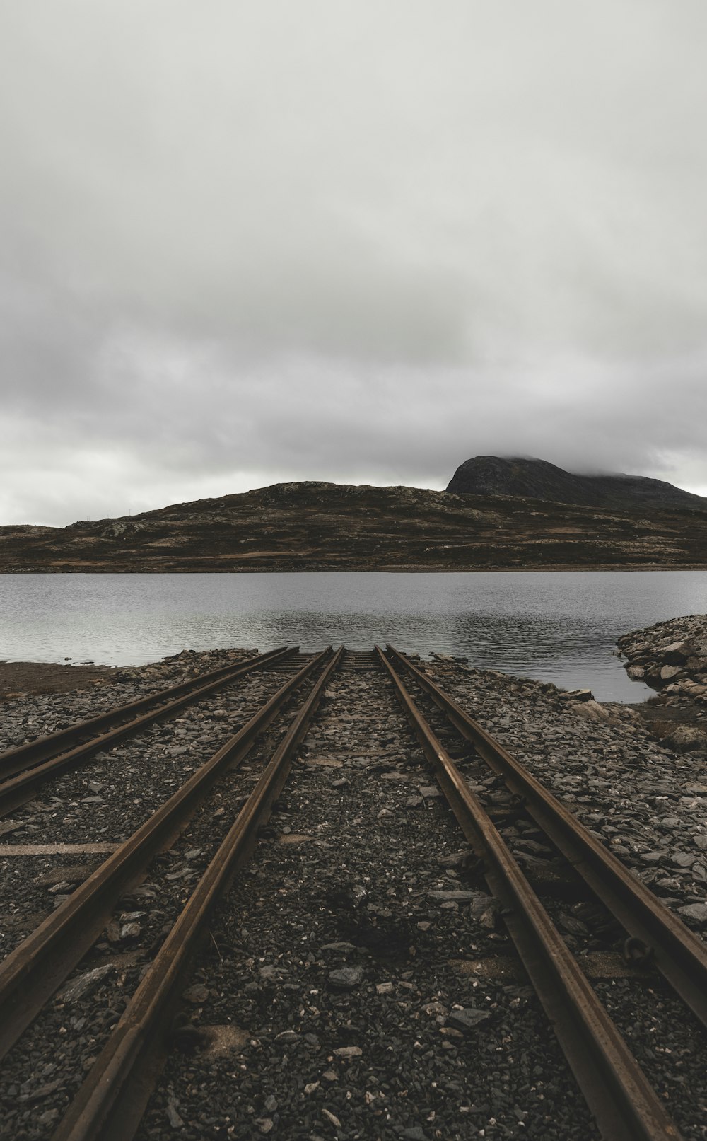 a view of a body of water from a train track