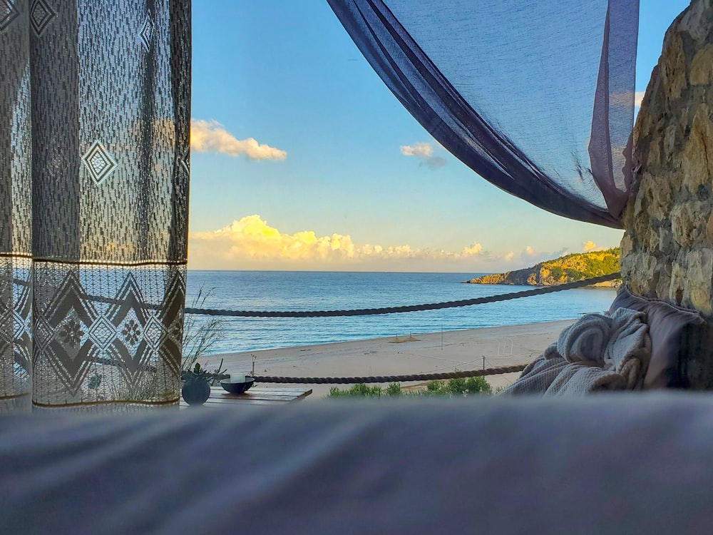 a view of the ocean from inside a tent