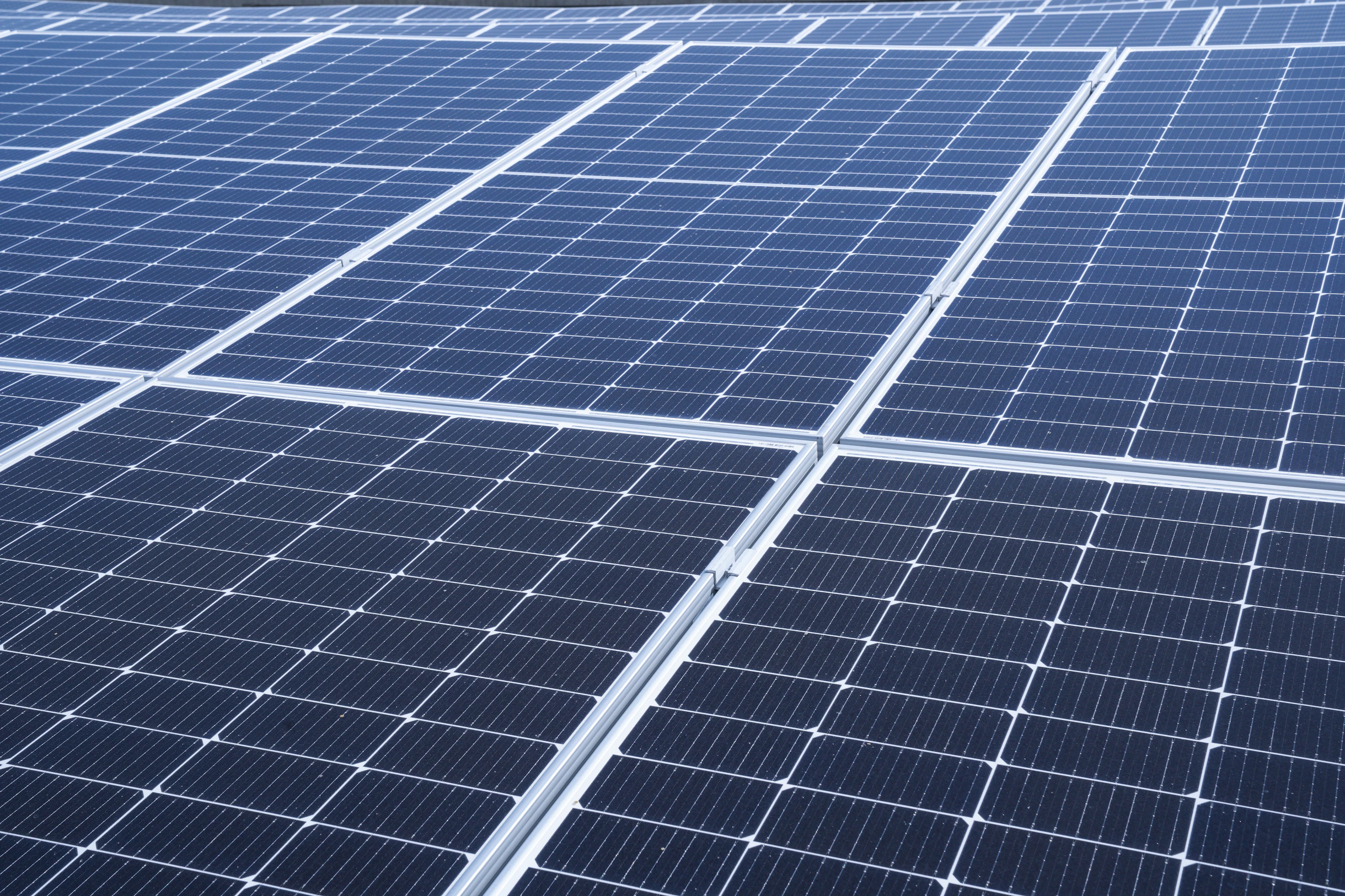 a large array of solar panels on the roof of a building