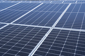 High-resolution photo of a modern solar panel installation on a sunny rooftop during daytime.