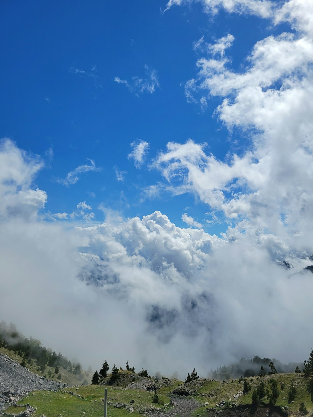 a view of a mountain covered in clouds