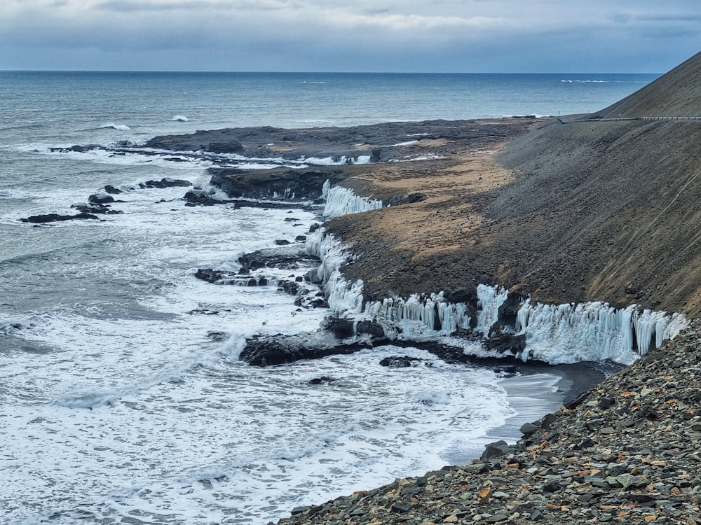 a view of the ocean from a rocky cliff