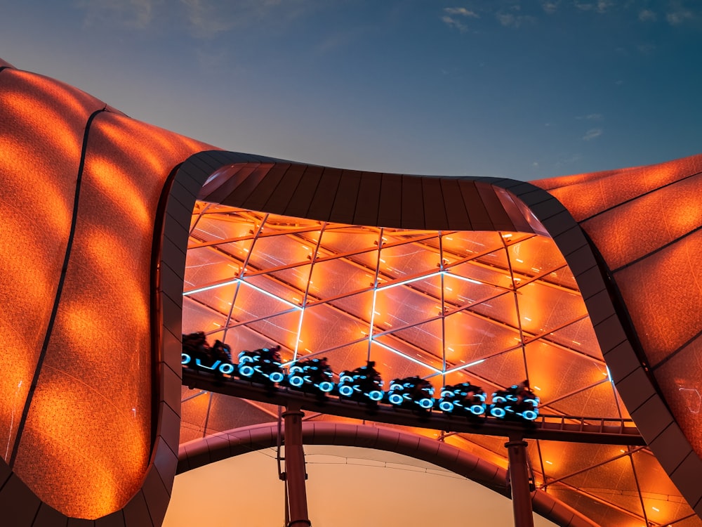 a building with a lit up roof and a sky background