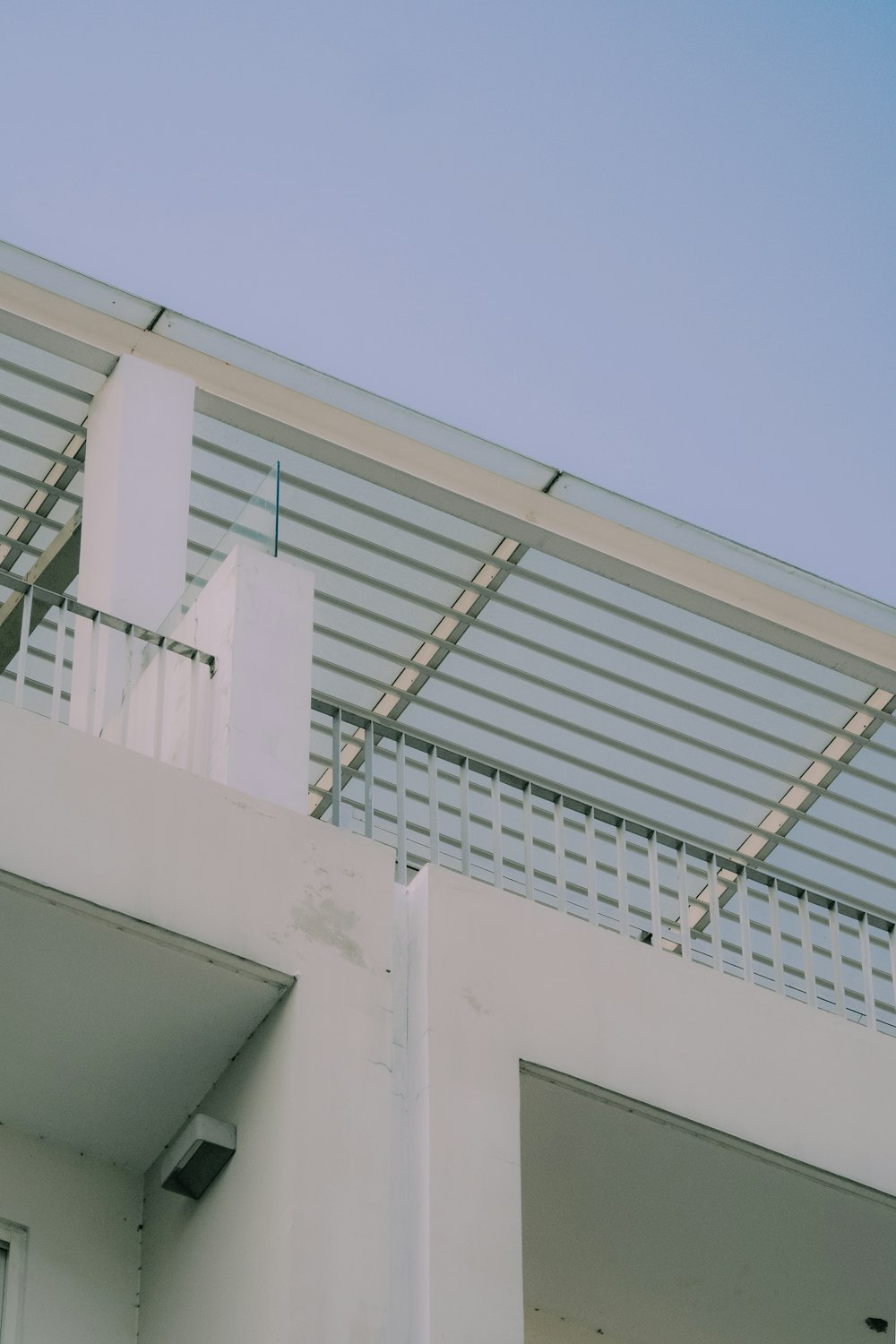 a white building with a metal roof and a white door