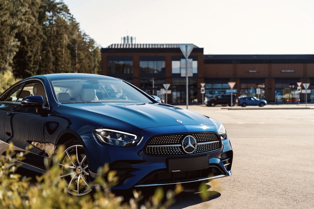 a blue car parked in front of a building