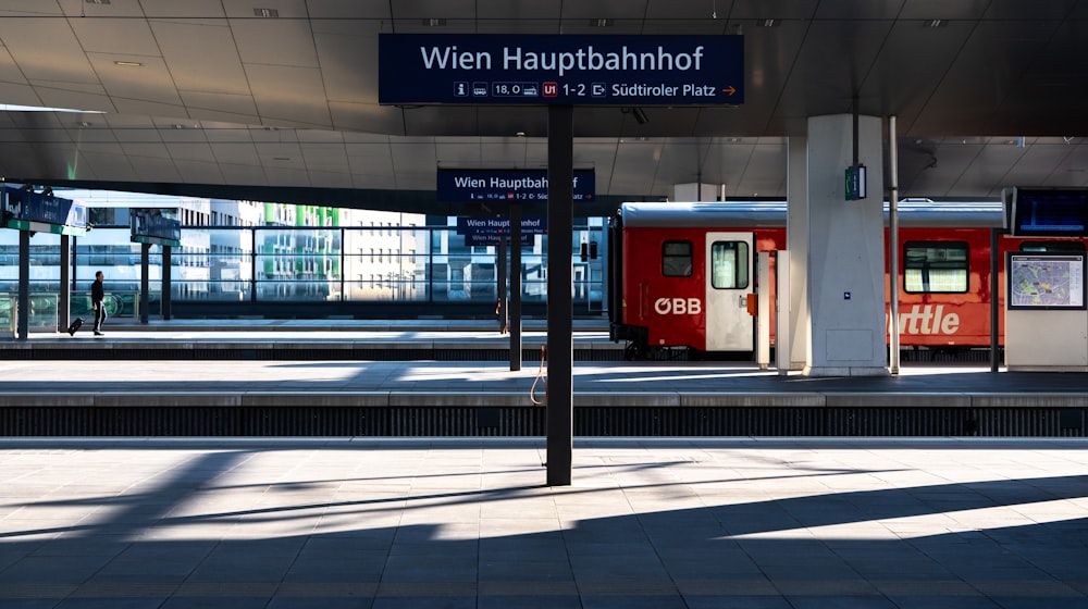 a train station with two trains parked next to each other