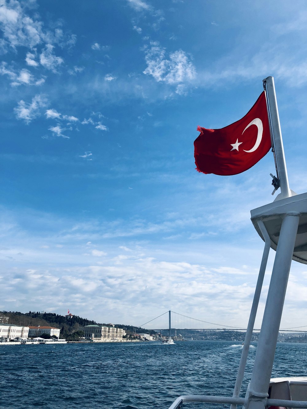 a turkish flag flying on the side of a boat