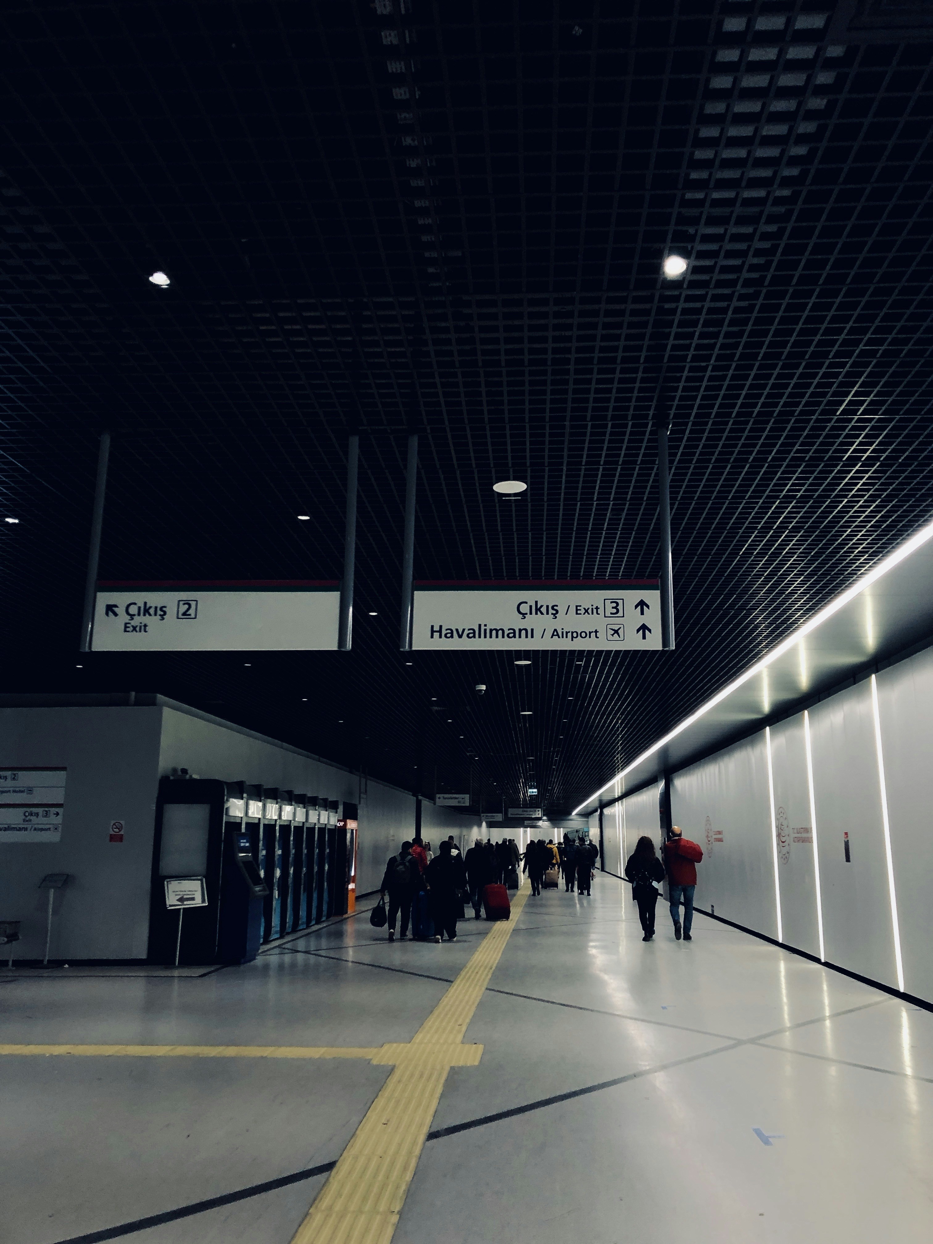 a group of people walking through an airport