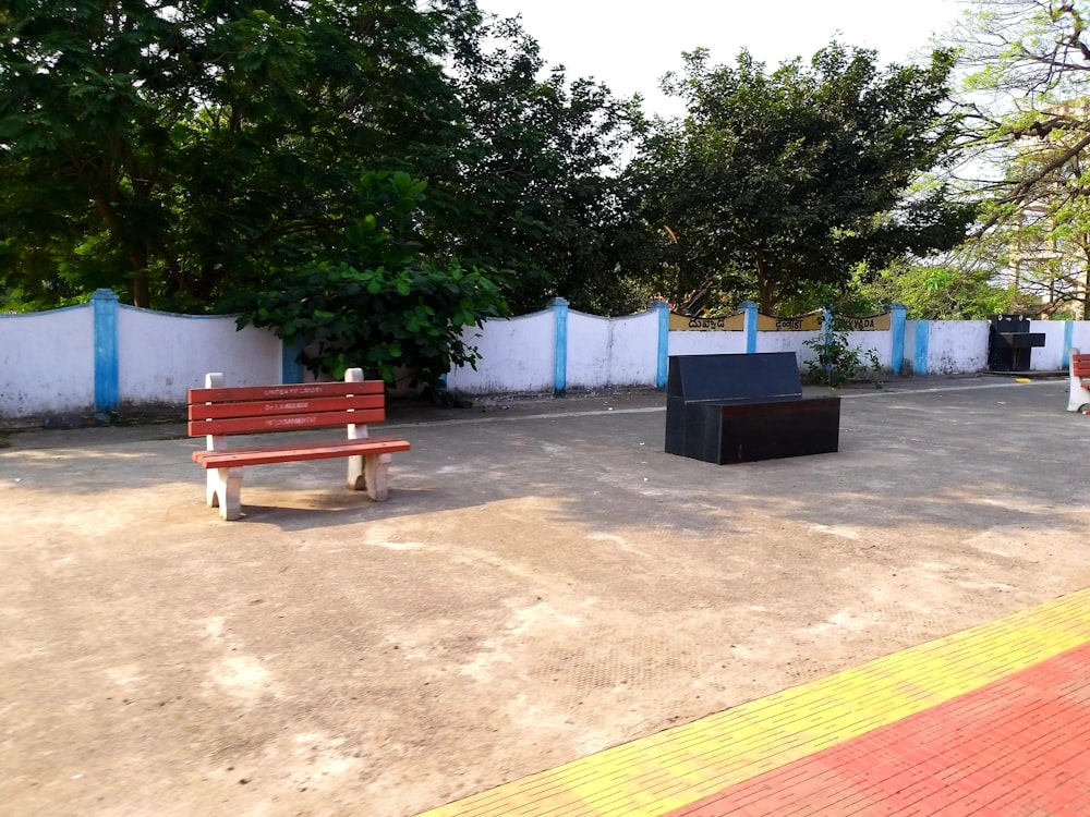 a couple of benches sitting on top of a cement ground