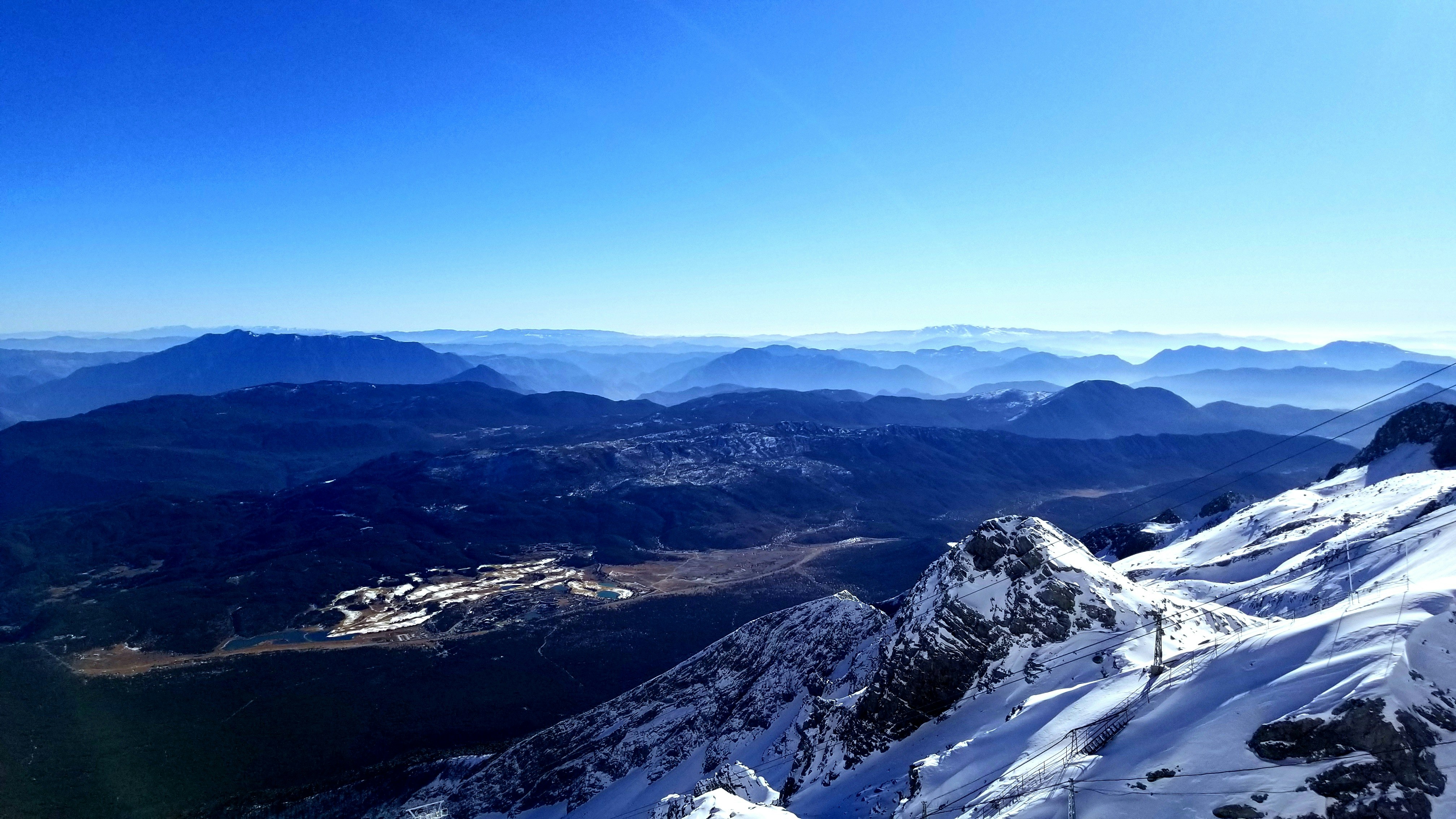 a view of a mountain range with snow on it