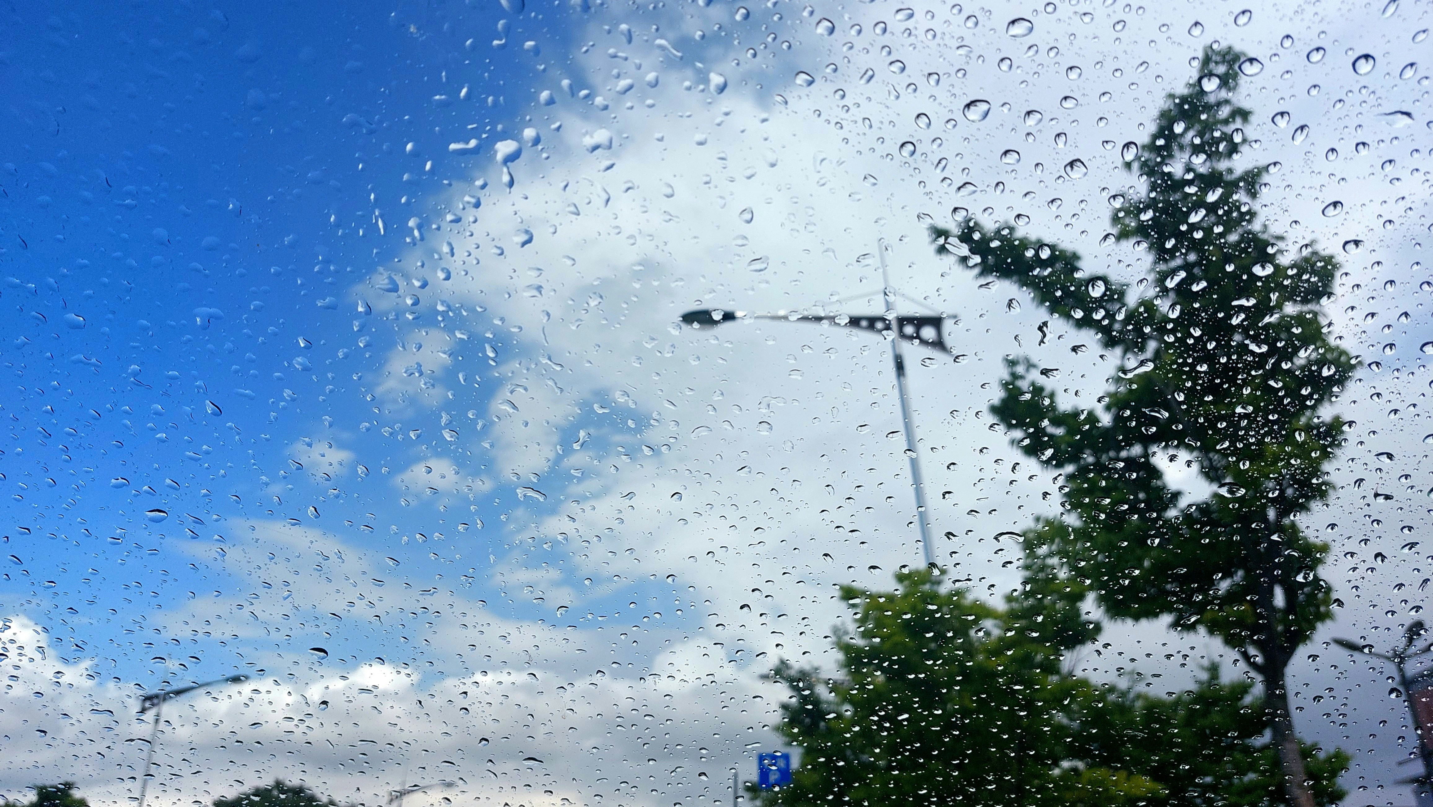 a view of a street through a rain covered window