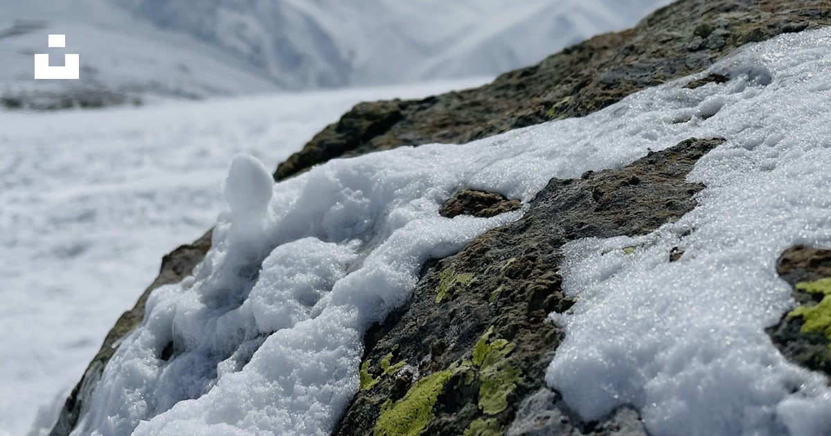 A rock covered in snow on top of a mountain photo – Free Travelling ...