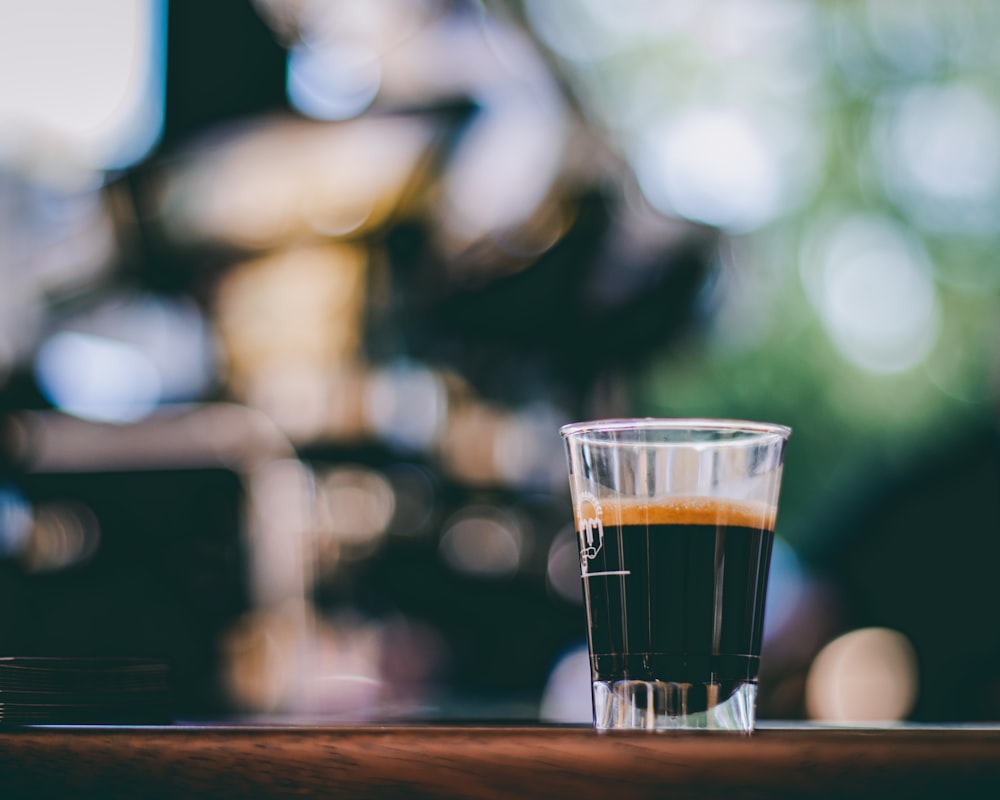 a shot glass sitting on top of a wooden table