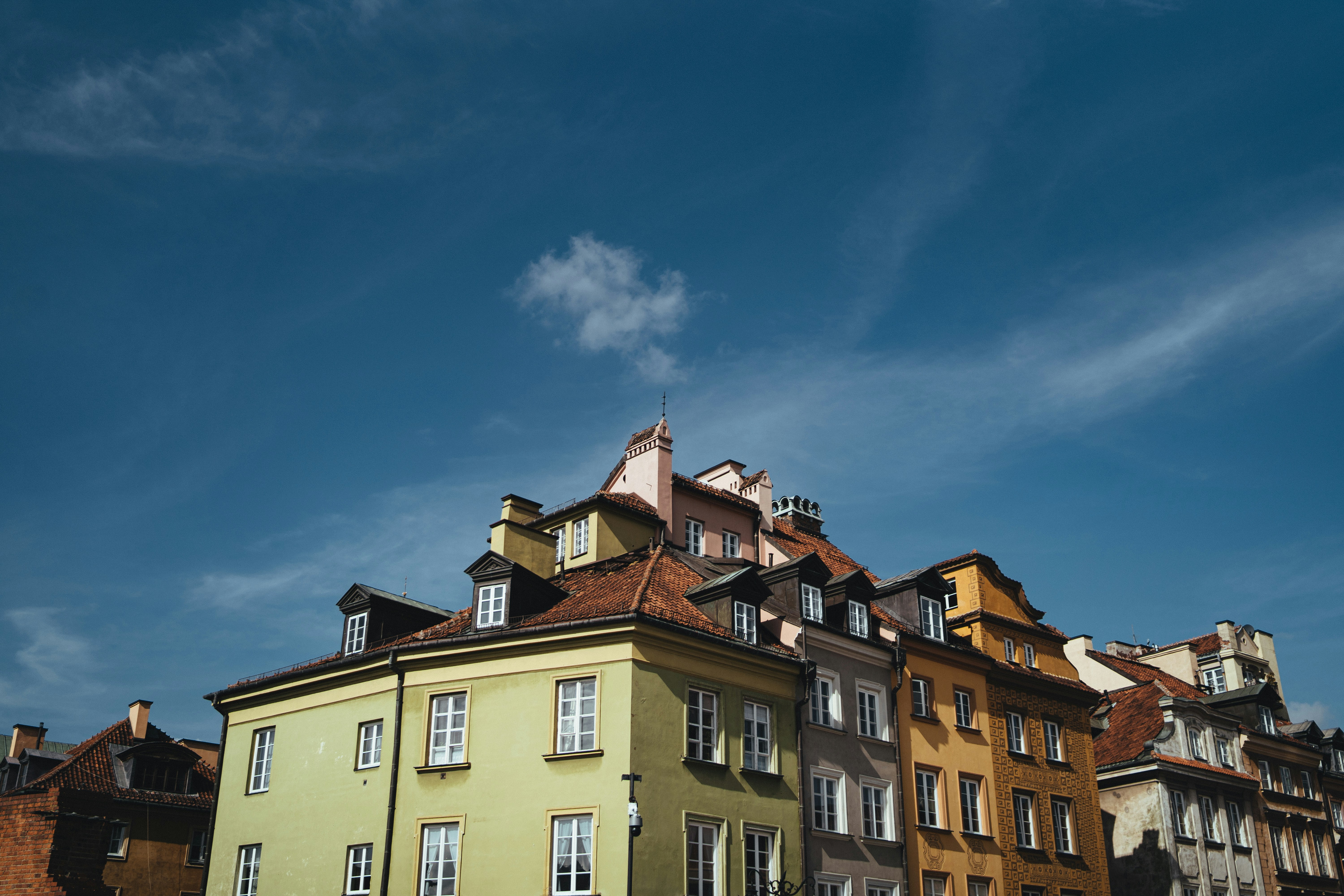 a row of buildings with a blue sky in the background, 