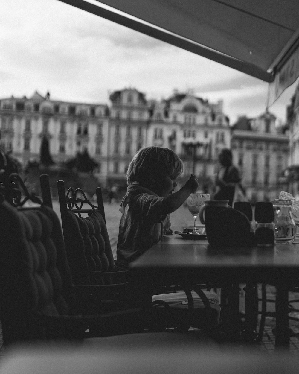 a little girl that is sitting at a table
