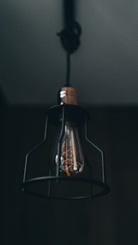 a light bulb hanging from the ceiling in a dark room