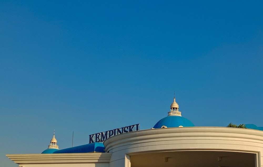 a large white building with a blue roof