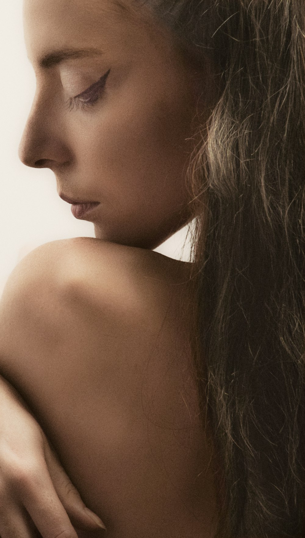 a woman with long hair is looking down