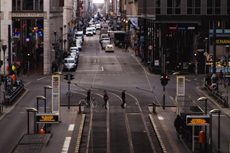 A busy urban street filled with commuters and public transport options.