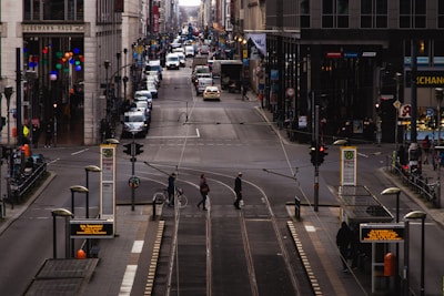 A busy urban street filled with commuters and public transport options.