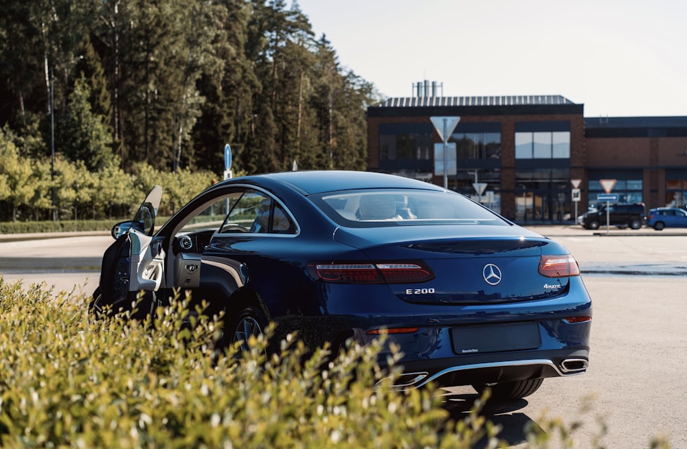 a blue car parked in a parking lot