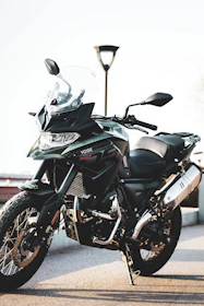 a black motorcycle parked next to a street light