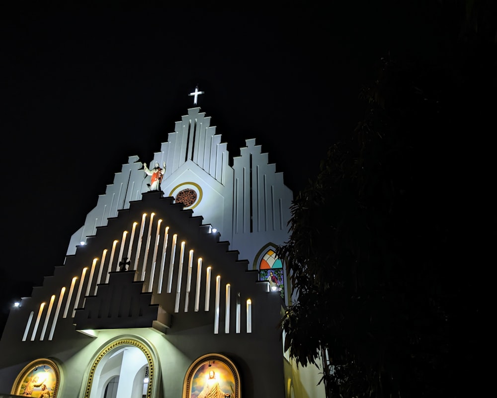 a church lit up at night with lights on