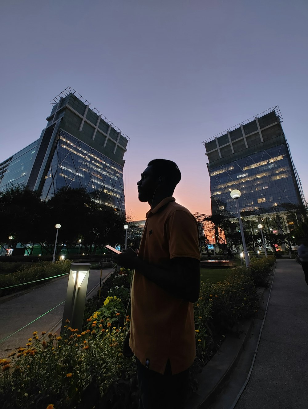 a man standing in front of a tall building