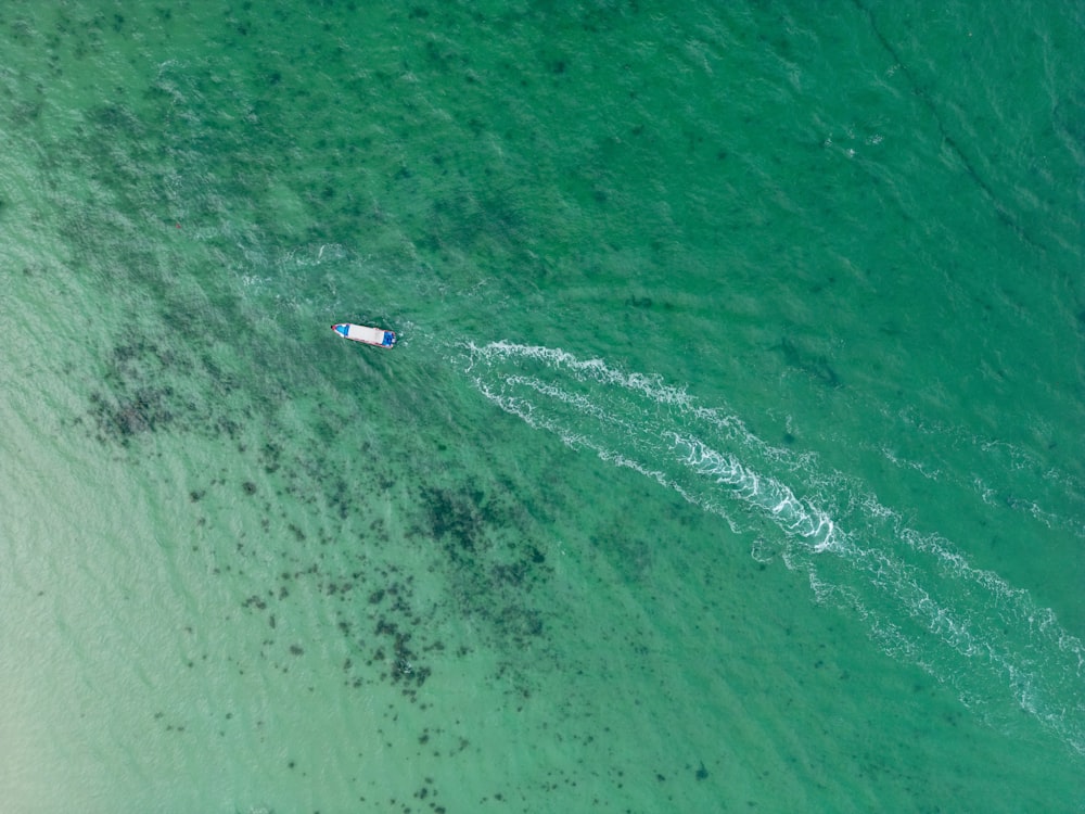 an aerial view of a boat in the ocean