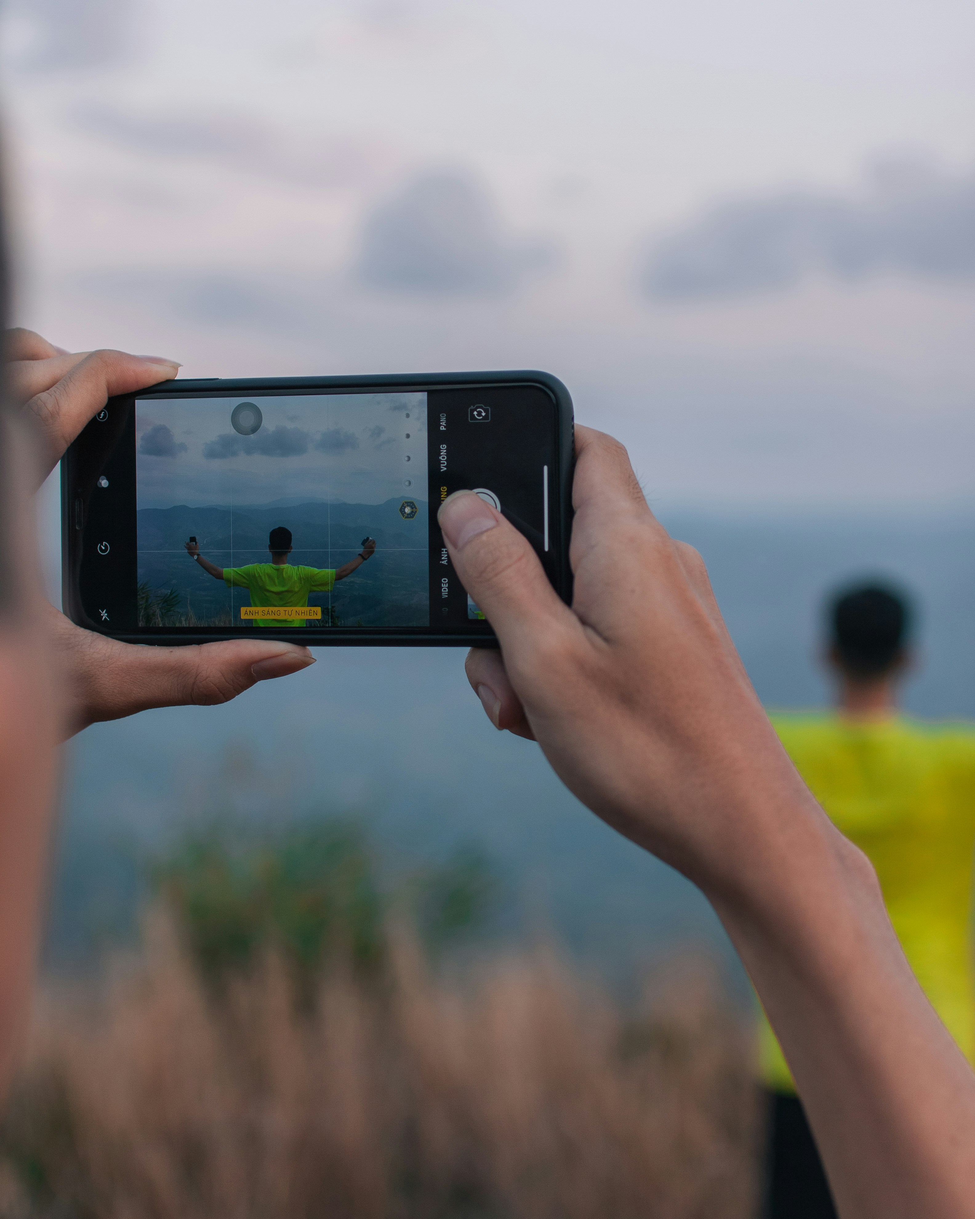 a person taking a picture with a cell phone